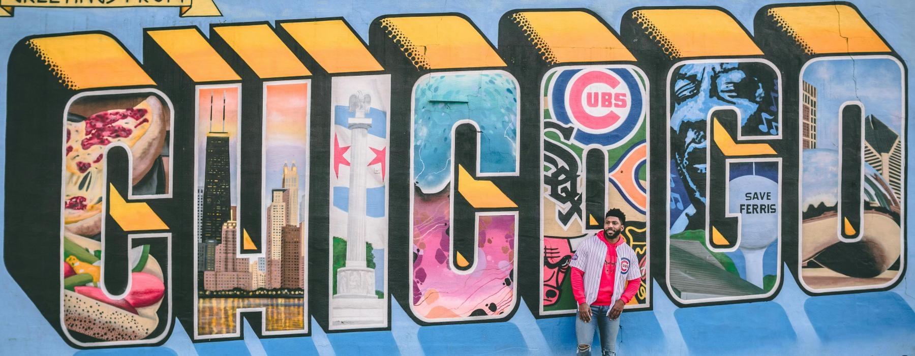 a person standing in front of a wall with graffiti